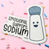 Sticker of a salt shaker with 'Emotional Support Sodium' text on a pink background with colorful sprinkles.