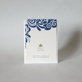 Image shows the back of a greeting card. It has a blue swoopy design with card details.