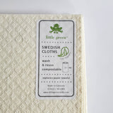 Image shows the back corner of a swedish dishcloth from Little Green. Sticker has product details.