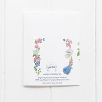 The back of the Transgender coming out card also features colorful watercolor flower illustrations matching the trans pride flag colors.