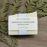 A light tan bar of Gentle and Unscented Bastille Soap sits against a natural background. The label shows it is a soap from MW Soapworks and is four ounces.