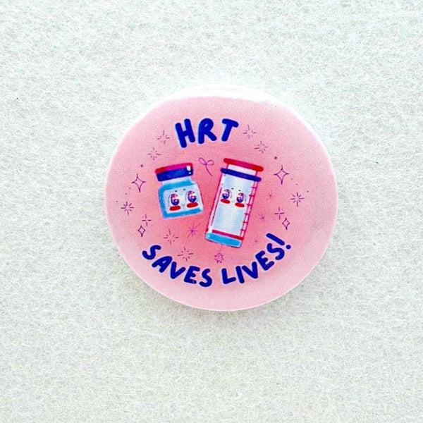 Pink button with HRT Saves Lives written across it with cartoon drawings of pill bottles.