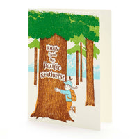 A greeting card features a young hiker with backpack hugging a tree. Text reads "Hugs from the Pacific Northwest"