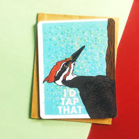 A greeting card has a woodpecker drawing with the text "I'd Tap That."