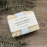 A bar of MW Soapworks Lemon Verbena Shea Butter Soap sits on a natural woodsy background.