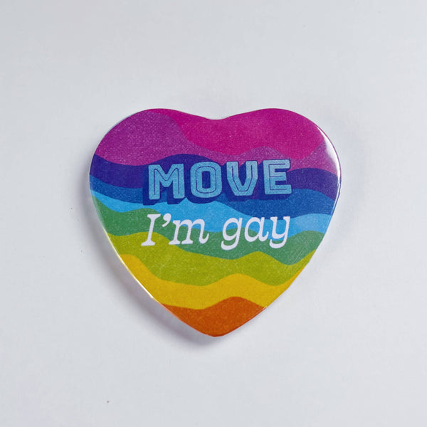 A heart shaped rainbow magnet says "move, I'm gay."