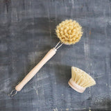 Two natural bristle brushes on a textured dark surface