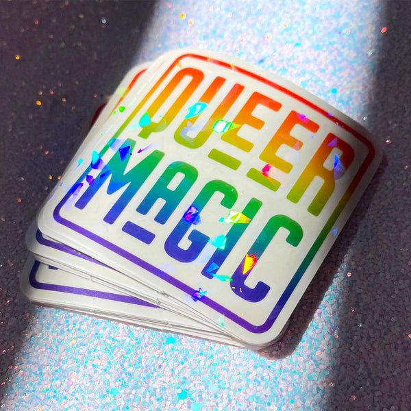 A shiny rainbow sticker reads "queer magic."