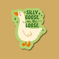 A playful blushing goose sticker sits on a tan background. The sticker says "Silly Goose on the Loose" in a fun font.