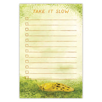 A to-do list notepad features a watercolor illustration of a slow Banana Slug. Along the top the words "Take It Slow" are written.