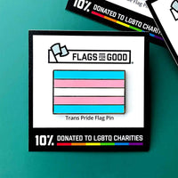 An enamel pin of the trans pride flag sits against a teal background. The label advertises that 10% of sales are donated to LGBTQ charities.