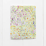 The back of Yardia's floral thank you card shows that the colorful watercolor floral design continues across the back.