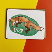 An adorable fox on a greeting card - text reads "you're a fox."